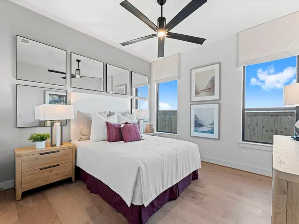 a bedroom with a bed a couch and dresser