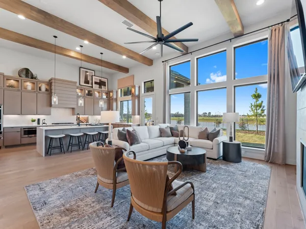 a living room with lots of furniture and a large window