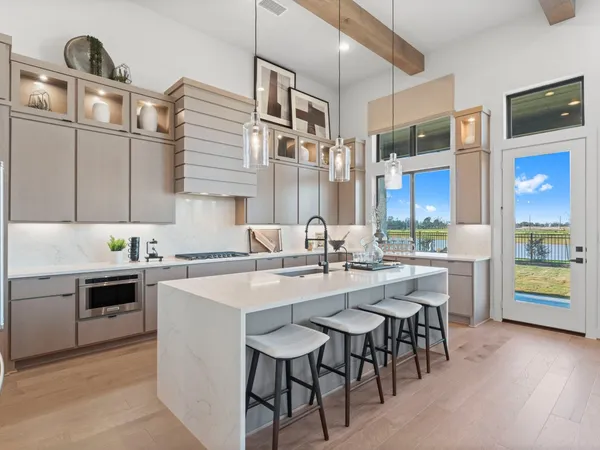 a kitchen with a sink stove and cabinets