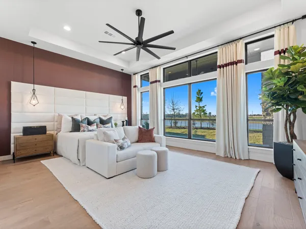 a living room with furniture a ceiling fan and a window