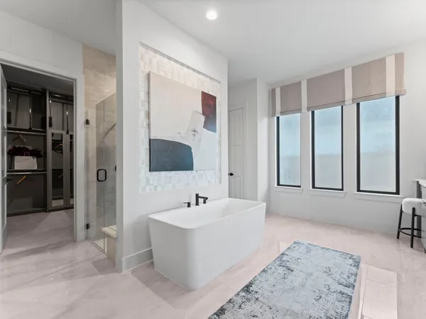 a spacious bathroom with a bathtub sink and mirror