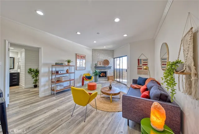a living room with fireplace furniture and a wooden floor