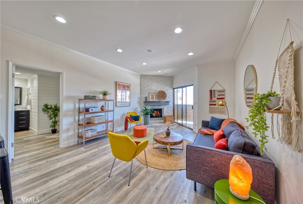 a living room with fireplace furniture and a wooden floor