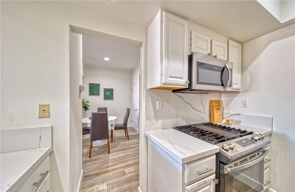 1665 Federal Avenue, Unit 302 Los Angeles, CA 90025 - Photo 14 of 31 a kitchen with a stove and a microwave