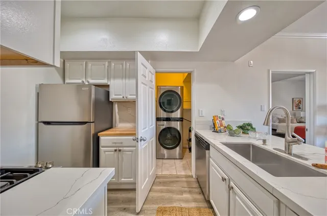 a kitchen with a refrigerator and a sink
