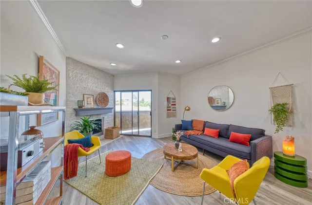 a living room with furniture kitchen view and a window
