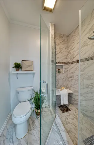 a bathroom with a toilet and a shower