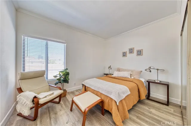 a bedroom with a bed and a potted plant