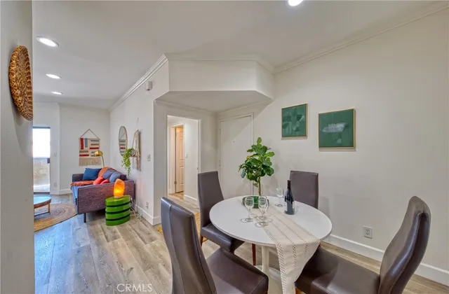 a view of a dining room with furniture wooden floor and kitchen