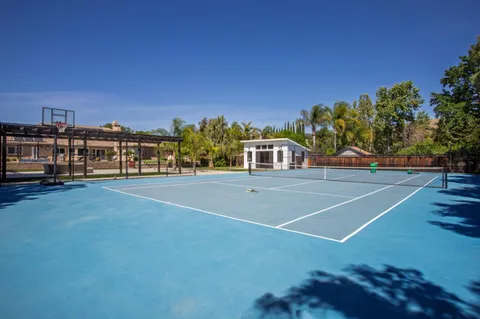 a view of street with deck and trees