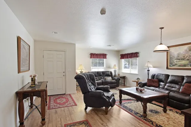 a living room with furniture a rug and a window