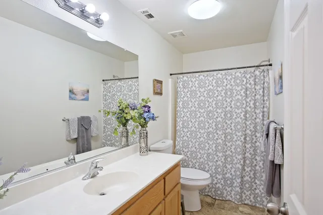 a bathroom with a sink toilet and shower