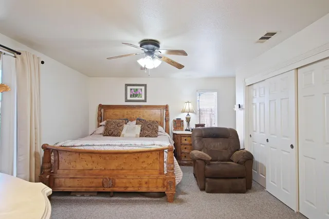 a bedroom with a bed couch and a window