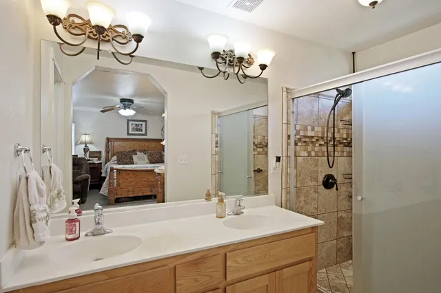 a bathroom with a sink double vanity and a mirror