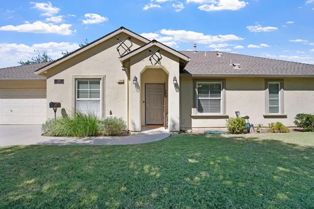 a front view of a house with a garden