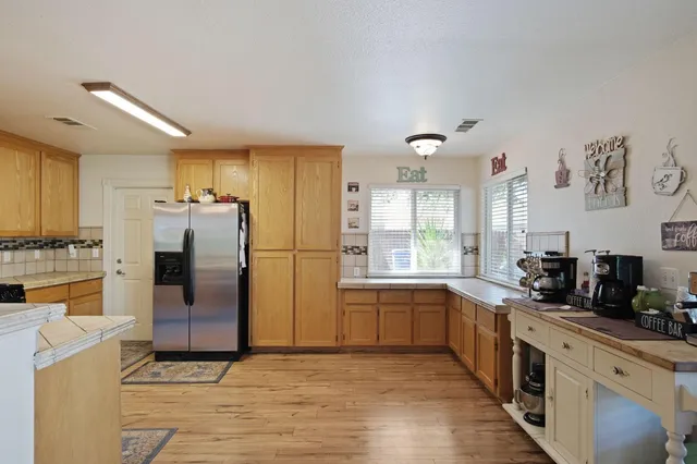 a kitchen with refrigerator cabinets and large window