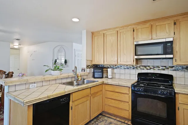 a kitchen with a sink stove and microwave