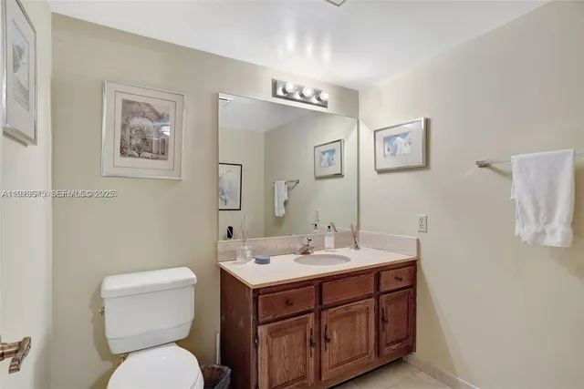 a spacious bedroom with a bed a table chair and glass door