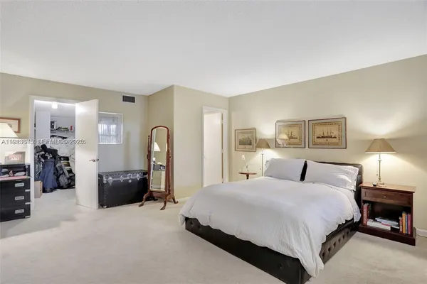 a bedroom with bed a couch and dresser