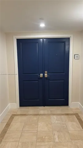 a living room with furniture large window and a table