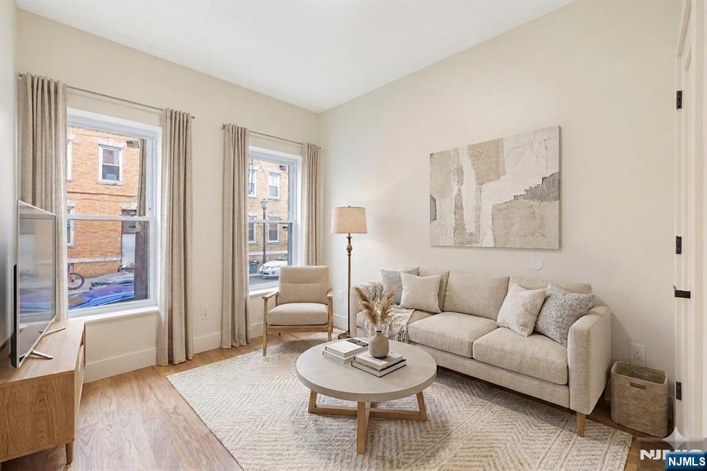 10 School Street, Unit 2 Passaic, NJ 07055 - Photo 3 of 11 a living room with furniture and a large window