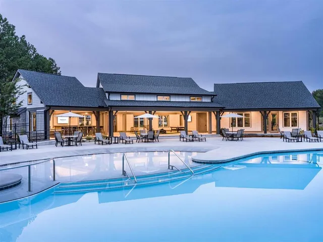 a view of a house with swimming pool and sitting area