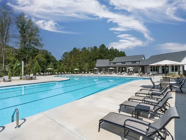 a view of a swimming pool with seating space