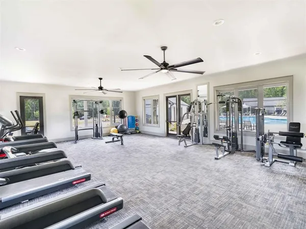 a living room with furniture a window and gym equipment