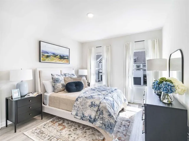 a bedroom with a bed and ceiling fan