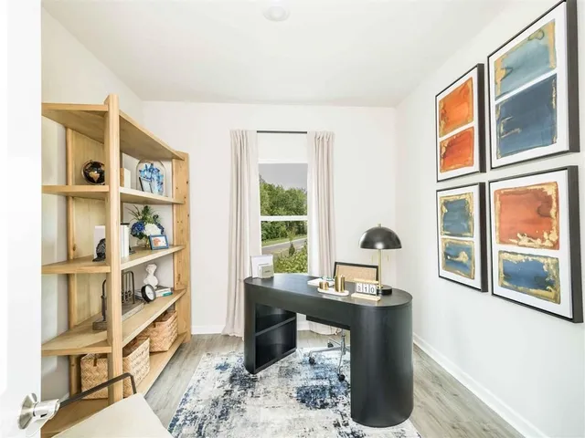 a living room with furniture fireplace and a window