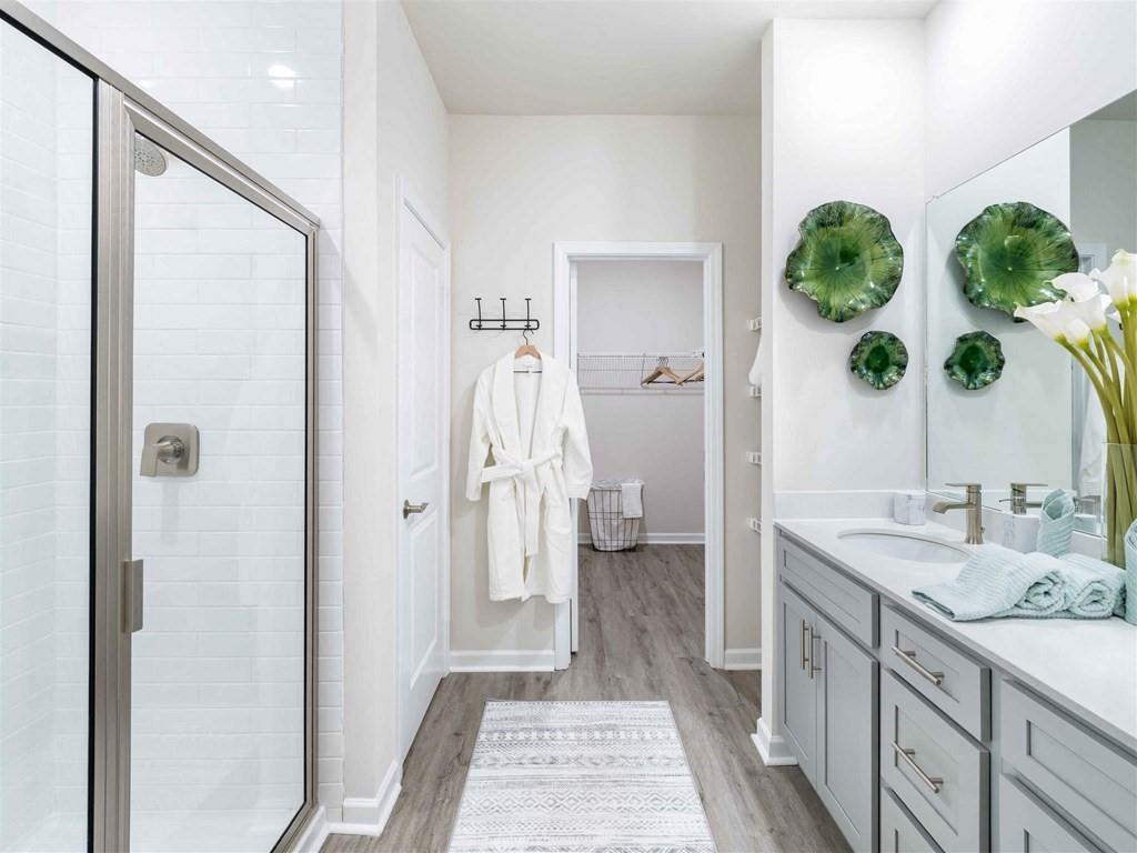 133 Pyramid Lane, Unit THC1 Hoschton, GA 30548 - Photo 9 of 20 a spacious bathroom with a granite countertop sink a mirror and a shower