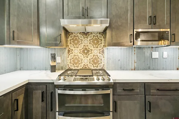 a stove top oven sitting inside of a kitchen