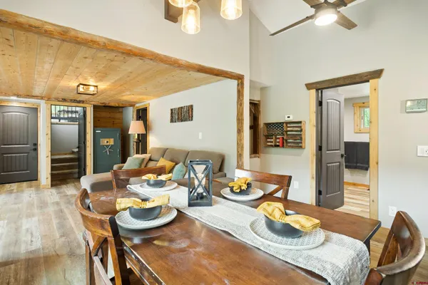 a dining room with furniture and a wooden floor