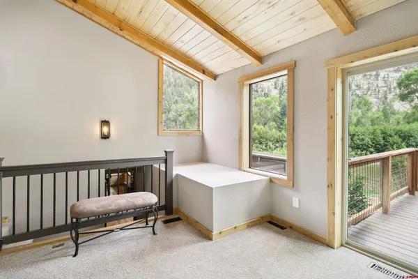 a spacious bedroom with a bed and a chandelier