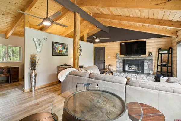 a living room with fireplace furniture and a flat screen tv
