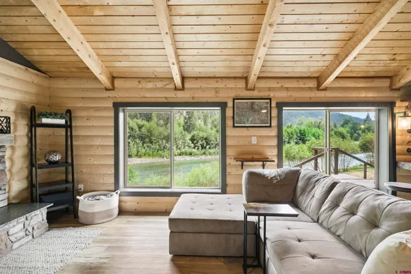 a living room with furniture and large windows