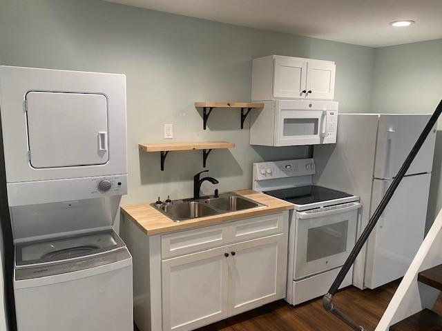 5919 River Road Flowery Branch, GA 30542 - Photo 16 of 18 a kitchen with white cabinets and white appliances
