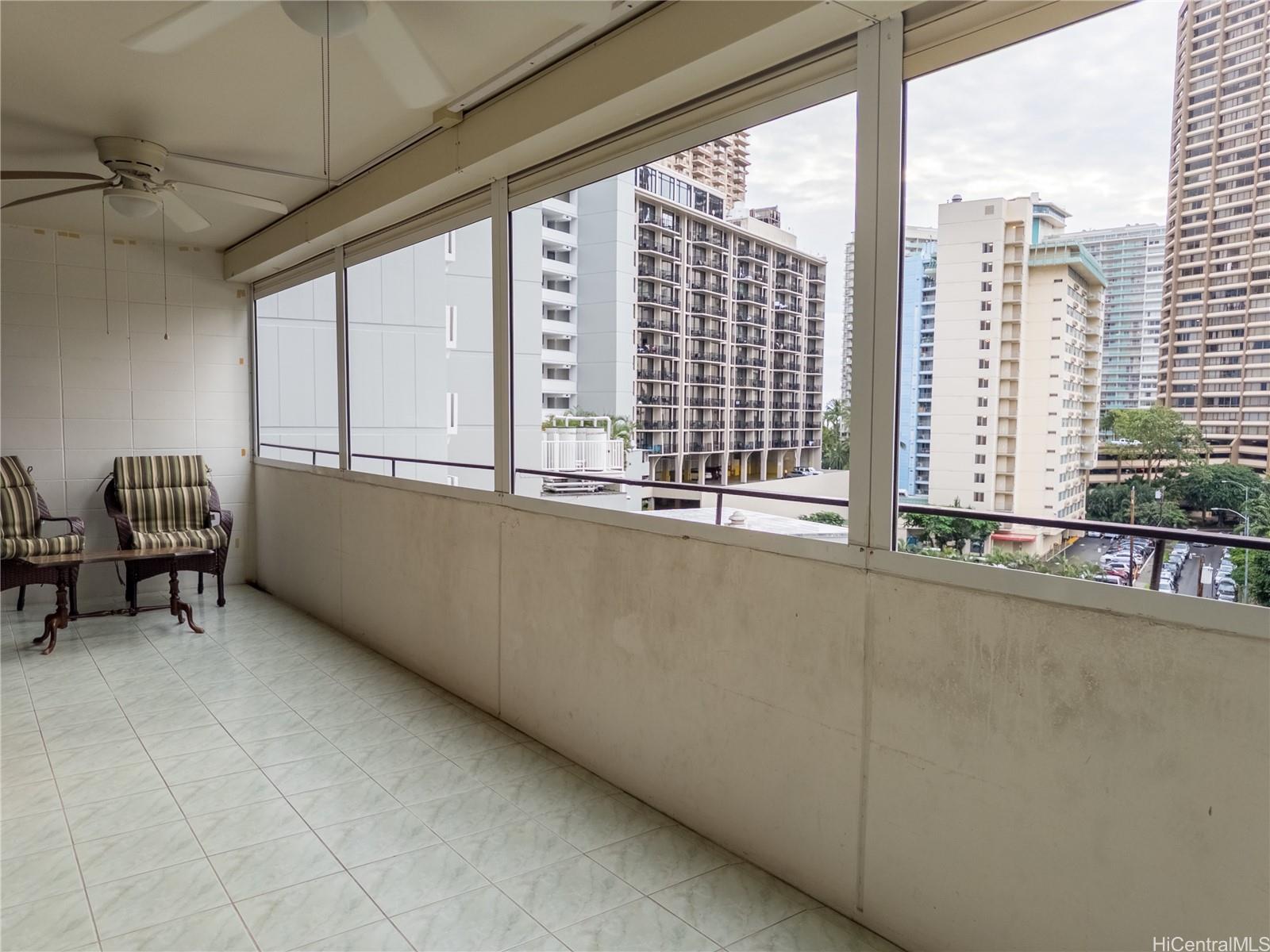 425 Ena Road, Unit 706B Honolulu, HI 96815 - Photo 11 of 23 a living room with a large window and furniture