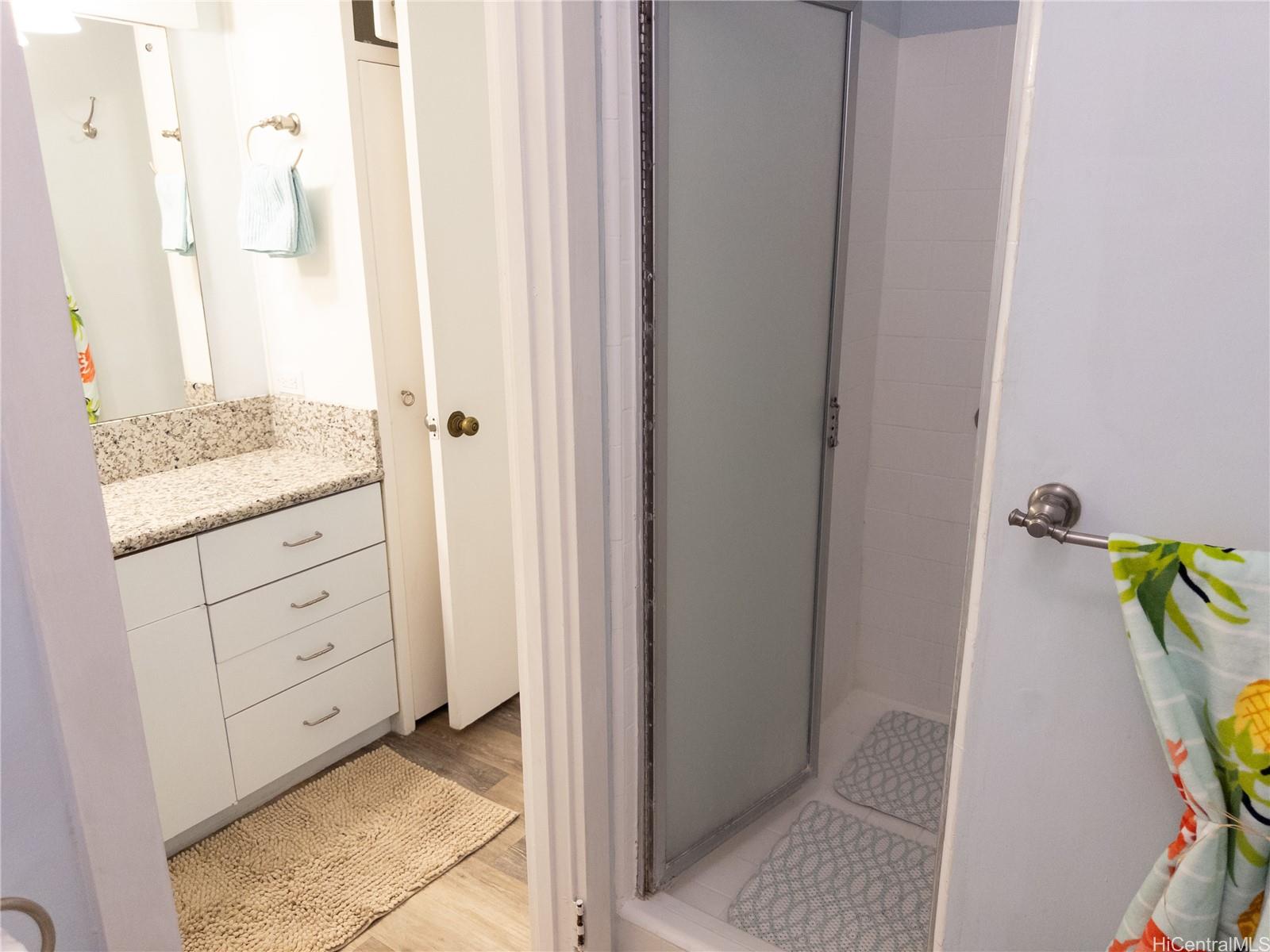 425 Ena Road, Unit 706B Honolulu, HI 96815 - Photo 12 of 23 a view of bathroom with a tub shower and a sink