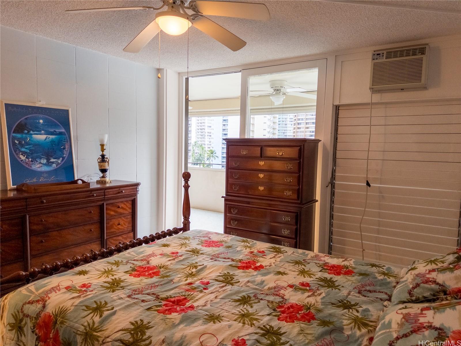 425 Ena Road, Unit 706B Honolulu, HI 96815 - Photo 6 of 23 a bedroom with a bed and a dresser