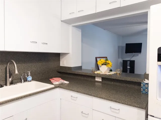 a kitchen with a sink and a mirror