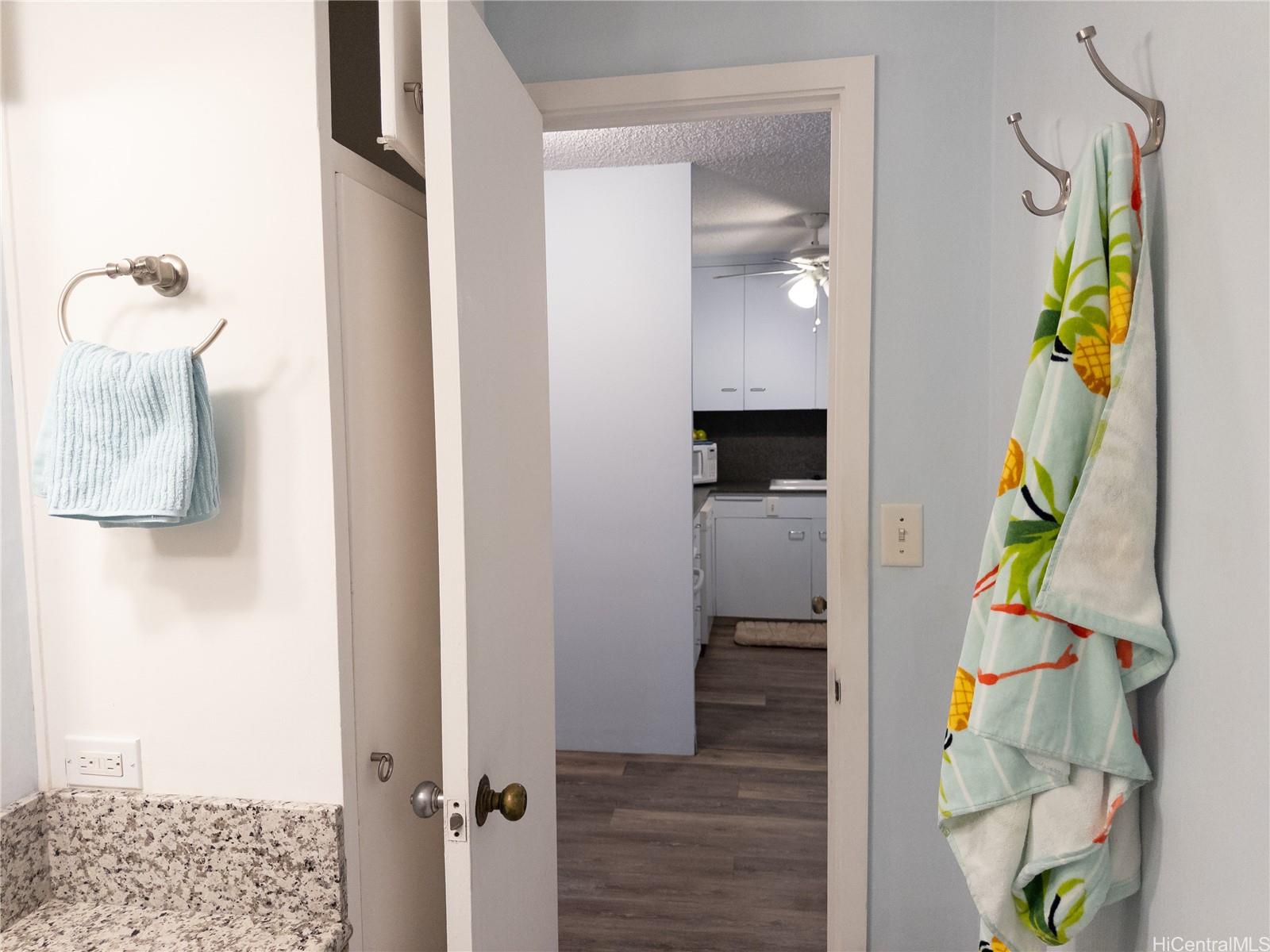 425 Ena Road, Unit 706B Honolulu, HI 96815 - Photo 10 of 23 view of hallway with stairs and wooden floor
