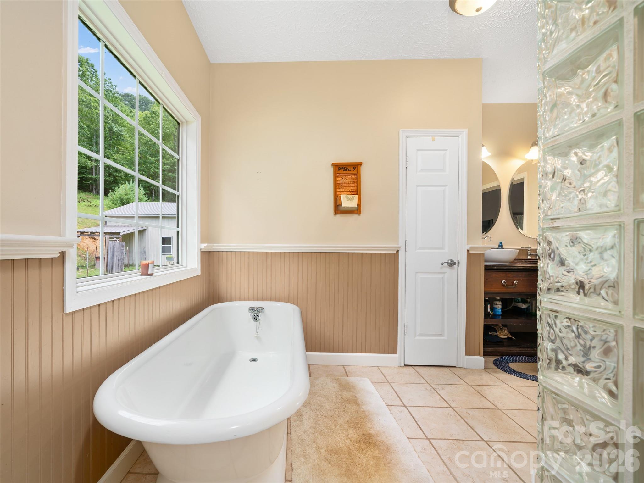2216 Beans Creek Road Bakersville, NC 28705 - Photo 17 of 39 a spacious bathroom with a bathtub and a sink