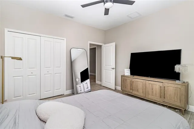 a bedroom with bed and flat screen tv