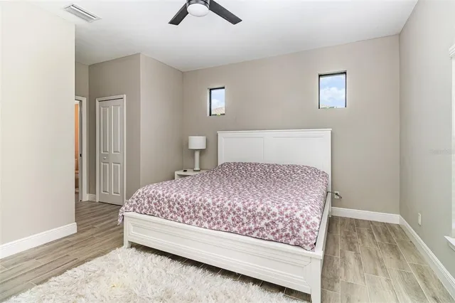 a bedroom with a bed and painting on the wall