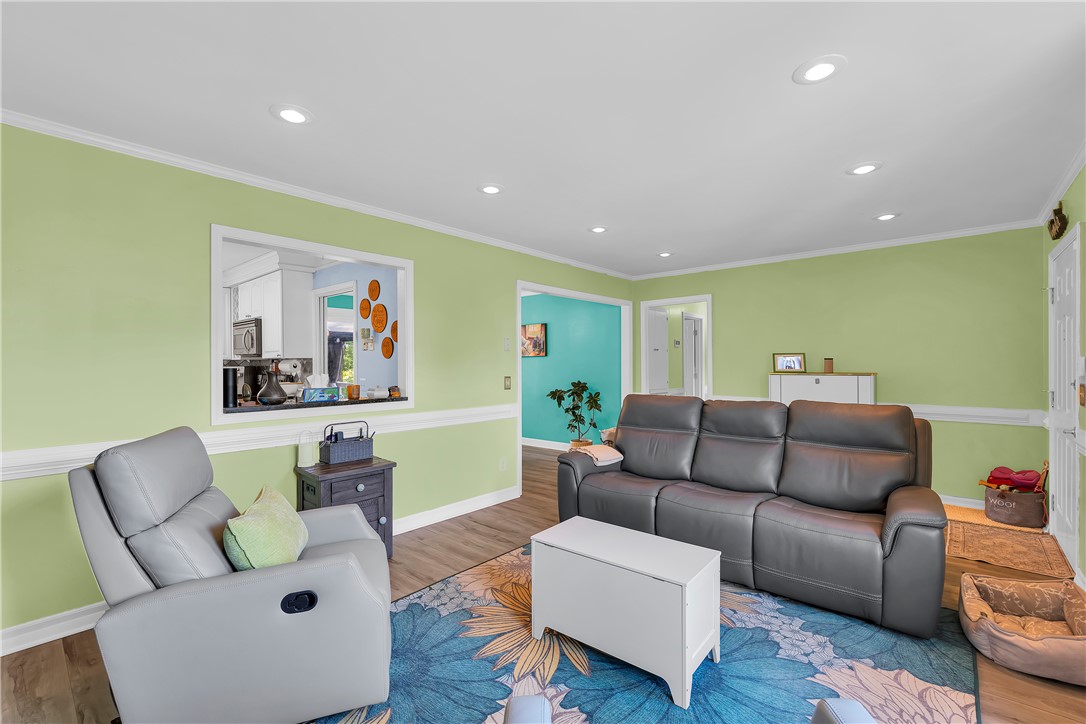 1305 Hanover Road Anderson, SC 29621 - Photo 4 of 29 Recessed lighting illuminates this inviting living space featuring a passthrough window and wood-look flooring.