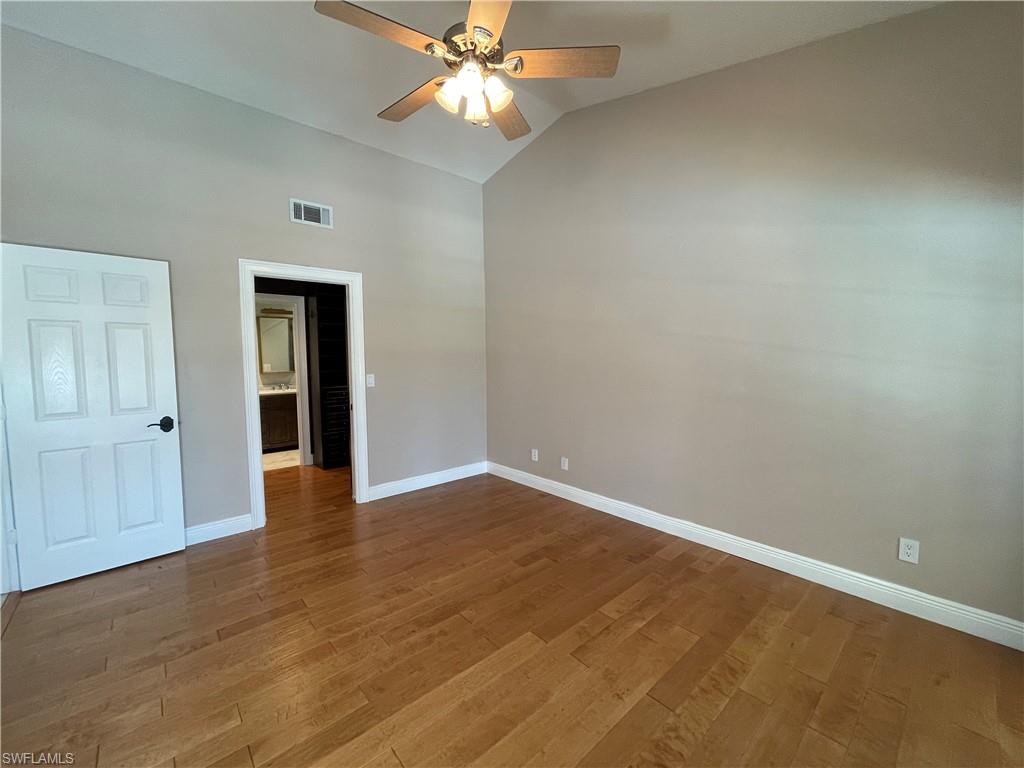 1380 Monarch Circle Naples, FL 34116 - Photo 11 of 21 a view of an empty room with wooden floor