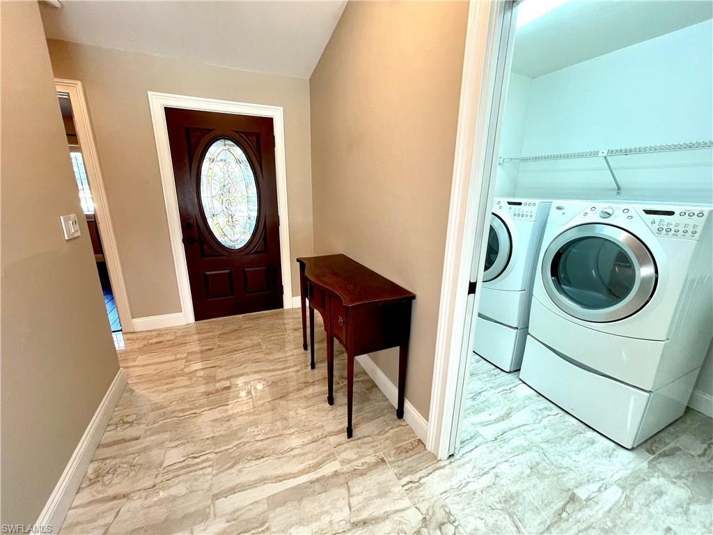 1380 Monarch Circle Naples, FL 34116 - Photo 2 of 21 a view of a hallway with washer and dryer