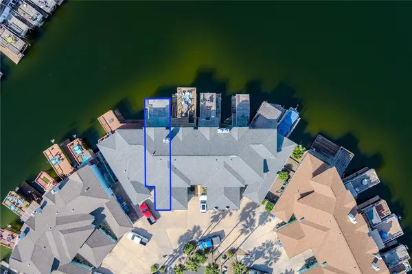 an aerial view of a house with outdoor space barbeque oven table and chairs in front of it