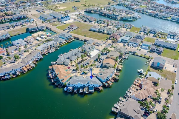 an aerial view of a house with a lake
